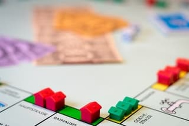 Photo of a monopoly game board with rental properties on the squares