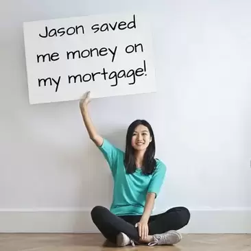 Photo of a woman holding a sign saying Jason saved me money on my mortgage