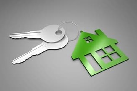photo of keys on a keychain shaped like a house representing the keys to a new house